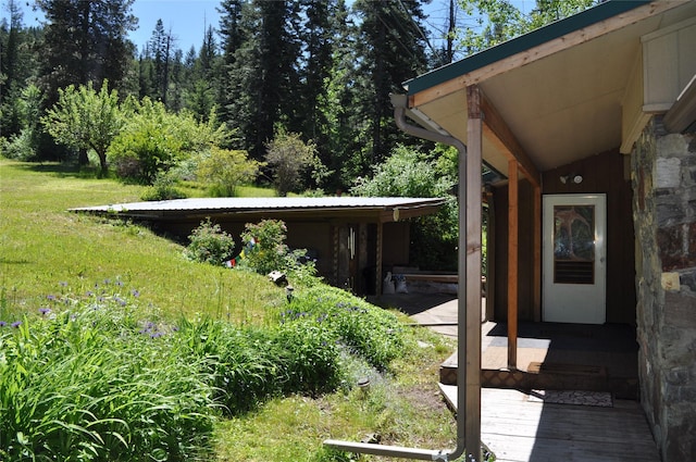 exterior space with a yard and stone siding