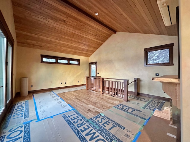 additional living space featuring wooden ceiling, wood finished floors, baseboards, and beam ceiling