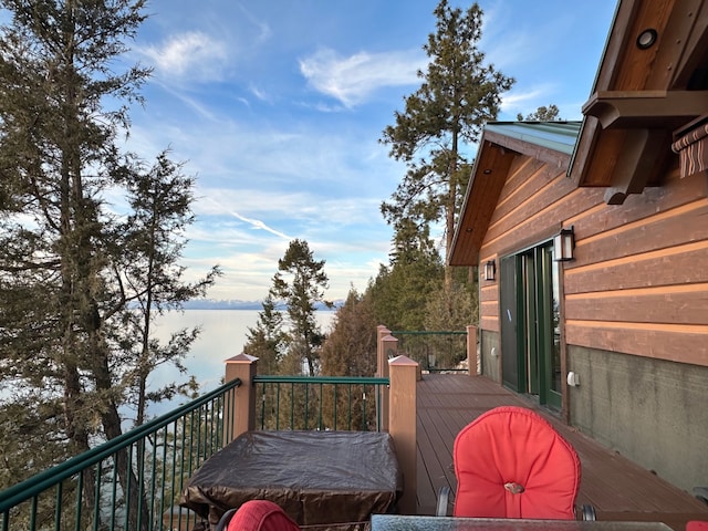 wooden terrace featuring a water view