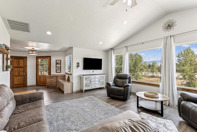 living area featuring visible vents, ceiling fan with notable chandelier, wood finished floors, recessed lighting, and lofted ceiling