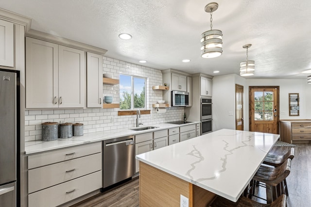 kitchen featuring open shelves, a wealth of natural light, appliances with stainless steel finishes, and a sink