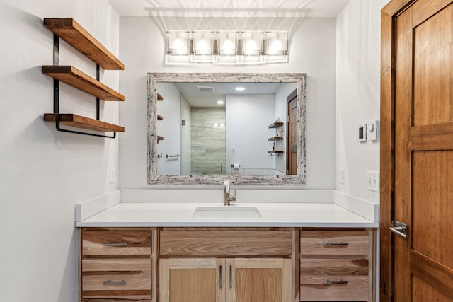 bathroom featuring visible vents, a shower stall, and vanity