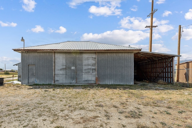 view of pole building with fence