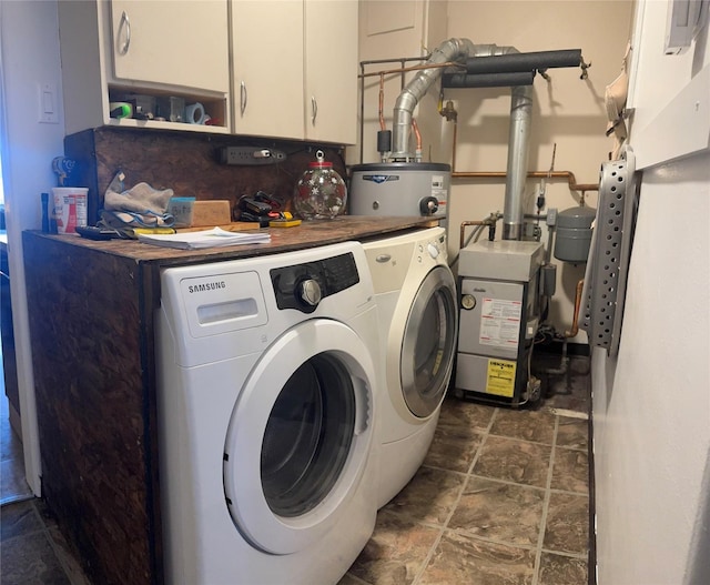 laundry area featuring cabinet space, washer and dryer, and a heating unit