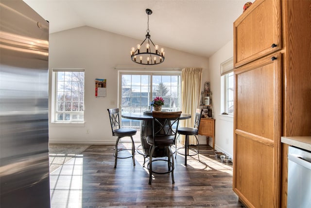 dining space with dark wood finished floors, a notable chandelier, a healthy amount of sunlight, and lofted ceiling