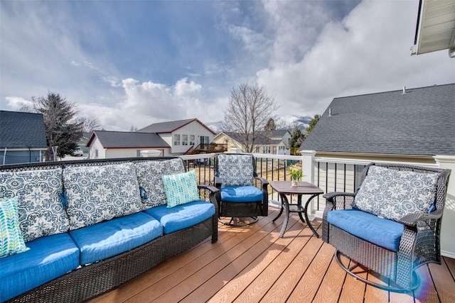 wooden terrace featuring a residential view and an outdoor living space