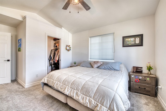 bedroom featuring a spacious closet, carpet flooring, baseboards, and vaulted ceiling