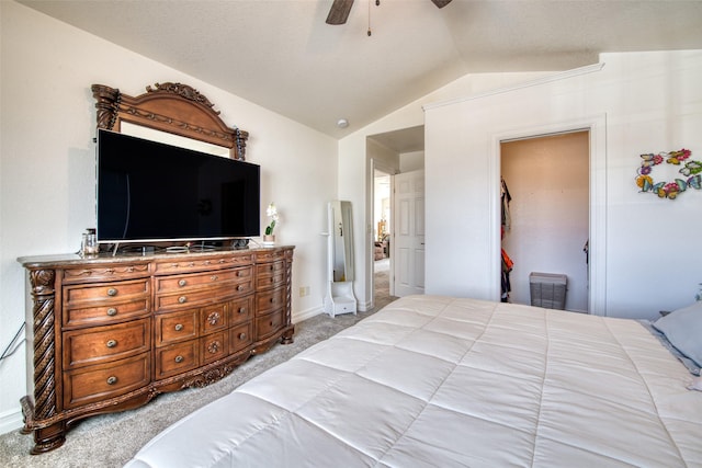 bedroom with a ceiling fan, vaulted ceiling, carpet, and baseboards