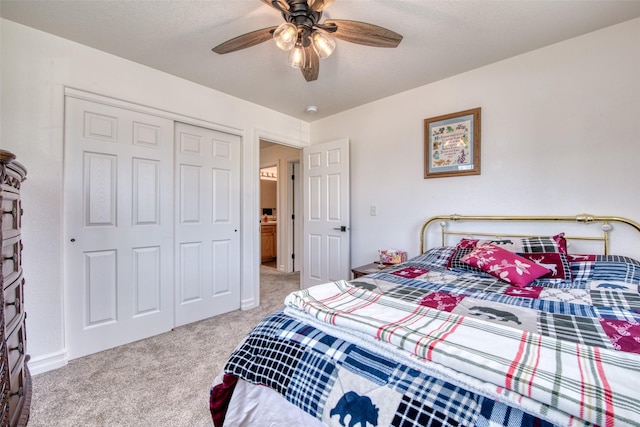 bedroom featuring a ceiling fan, a closet, and light carpet