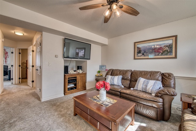 living room with light colored carpet, baseboards, and ceiling fan