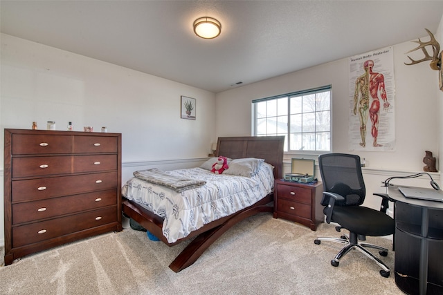 bedroom featuring light carpet and visible vents