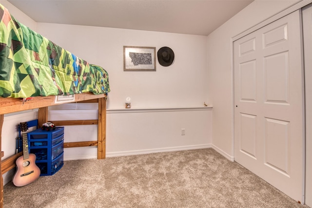 bedroom with carpet and baseboards