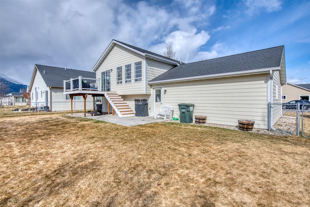 rear view of house with fence, stairway, a yard, a wooden deck, and a patio area