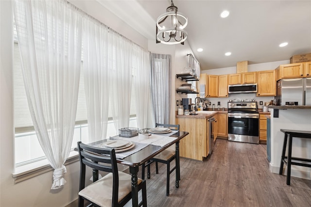 278 Empire Loop, Kalispell, MT 59901 - kitchen featuring appliances with stainless steel finishes, a sink, a chandelier, dark wood-type flooring, and light brown cabinets