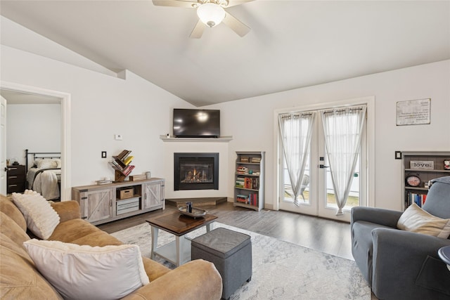 278 Empire Loop, Kalispell, MT 59901 - living room with vaulted ceiling, wood finished floors, a ceiling fan, and a glass covered fireplace