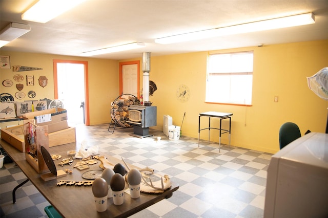 3676 Silverthorn Dr, Stevensville, MT 59870 - below grade area featuring tile patterned floors and a wood stove