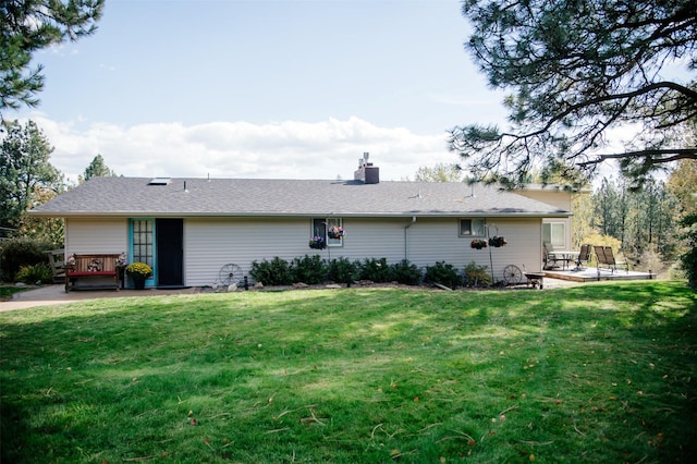 3676 Silverthorn Dr, Stevensville, MT 59870 - back of house featuring a chimney, a wooden deck, a yard, and a patio area