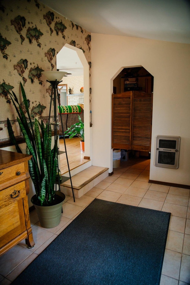 3676 Silverthorn Dr, Stevensville, MT 59870 - hallway featuring heating unit, wallpapered walls, light tile patterned flooring, and arched walkways