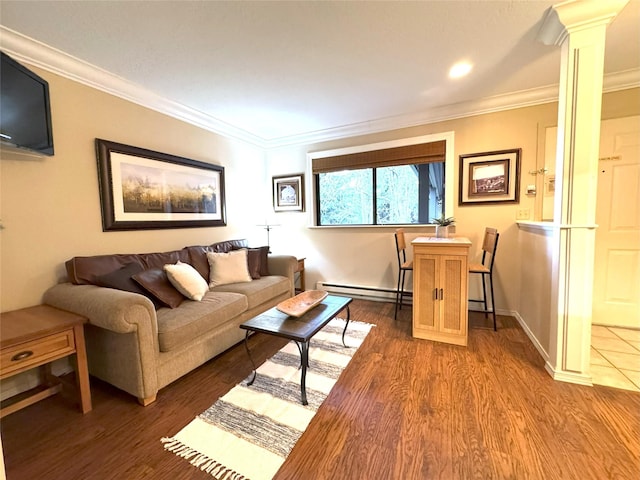 180 Vista Ln Unit 238, Bigfork, MT 59911 - living room featuring decorative columns, wood finished floors, a baseboard heating unit, ornamental molding, and baseboards