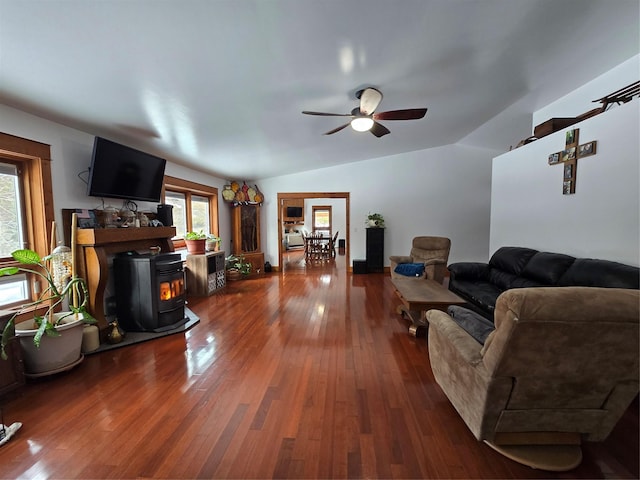 611 S Canyon Dr, Seeley Lake, MT 59868 - living area with a wood stove, healthy amount of natural light, lofted ceiling, a ceiling fan, and wood-type flooring