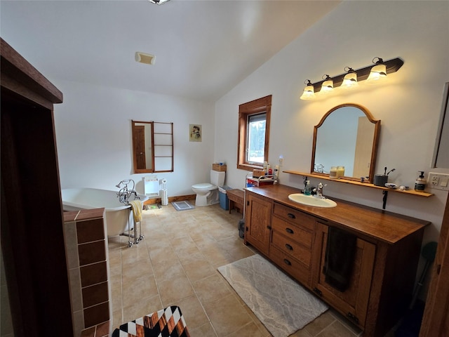 611 S Canyon Dr, Seeley Lake, MT 59868 - bathroom featuring lofted ceiling, a soaking tub, vanity, and tile patterned flooring