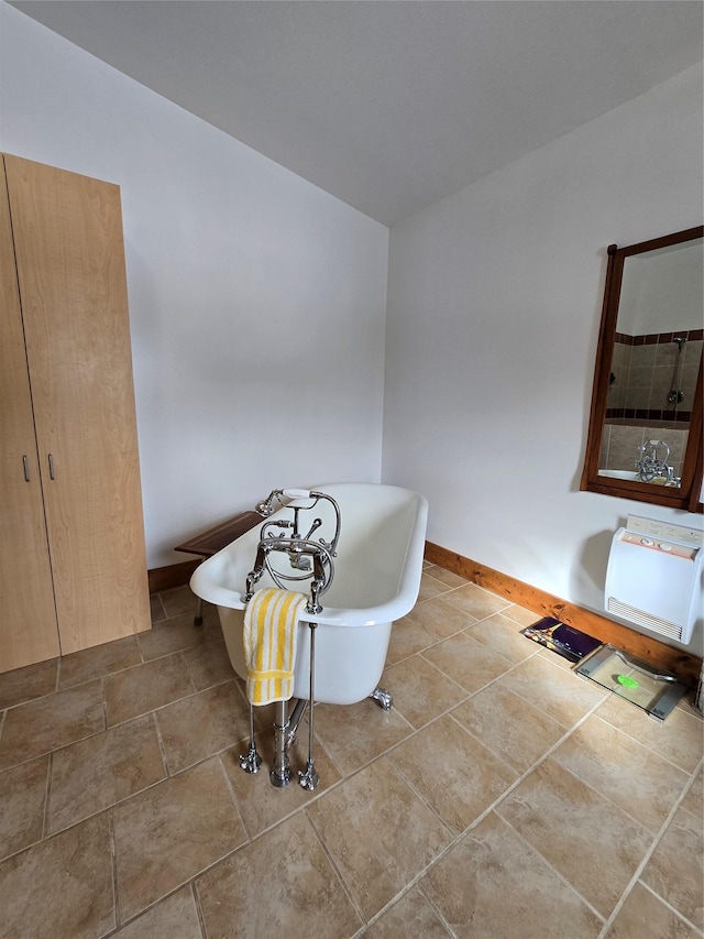 611 S Canyon Dr, Seeley Lake, MT 59868 - bathroom with a freestanding tub and baseboards