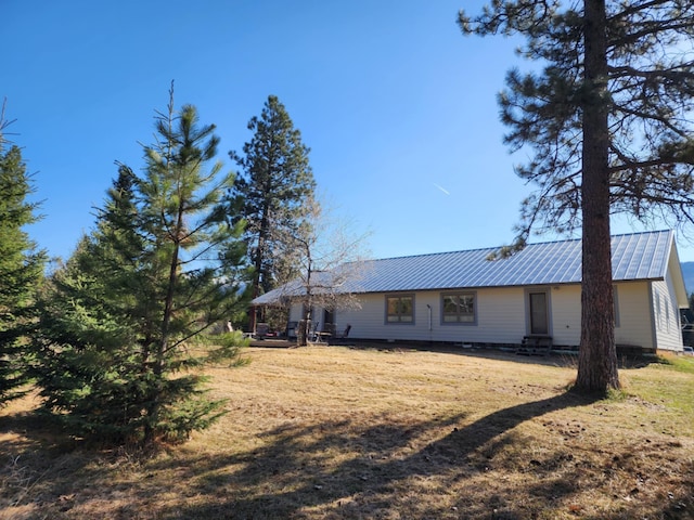 611 S Canyon Dr, Seeley Lake, MT 59868 - rear view of house featuring a metal roof