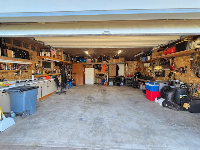 611 S Canyon Dr, Seeley Lake, MT 59868 - garage with a workshop area and freestanding refrigerator