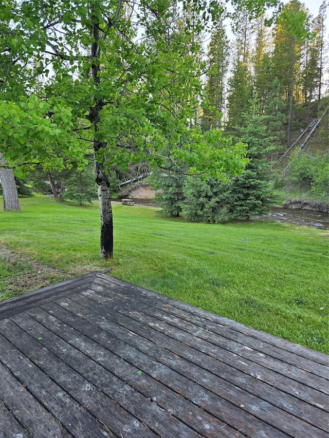 611 S Canyon Dr, Seeley Lake, MT 59868 - wooden terrace with a lawn
