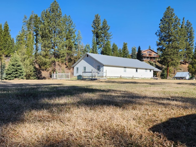 611 S Canyon Dr, Seeley Lake, MT 59868 - view of side of home featuring a metal roof and a lawn