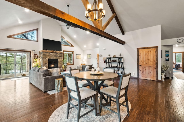 378 Skookum Rd, Lakeside, MT 59922 - dining area with high vaulted ceiling, beam ceiling, dark wood-style flooring, a chandelier, and a fireplace