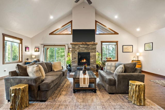 378 Skookum Rd, Lakeside, MT 59922 - living area with wood finished floors, high vaulted ceiling, a ceiling fan, baseboards, and a fireplace