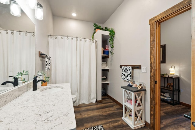 378 Skookum Rd, Lakeside, MT 59922 - full bath featuring wood finished floors, baseboards, toilet, vanity, and recessed lighting