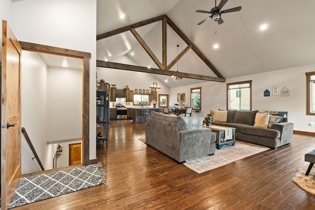 378 Skookum Rd, Lakeside, MT 59922 - living room with high vaulted ceiling, dark wood-style flooring, a ceiling fan, recessed lighting, and beamed ceiling