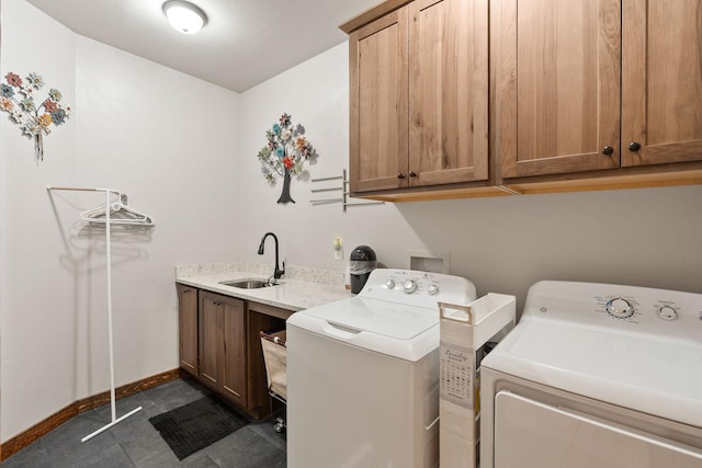 378 Skookum Rd, Lakeside, MT 59922 - clothes washing area featuring washing machine and dryer, cabinet space, and baseboards