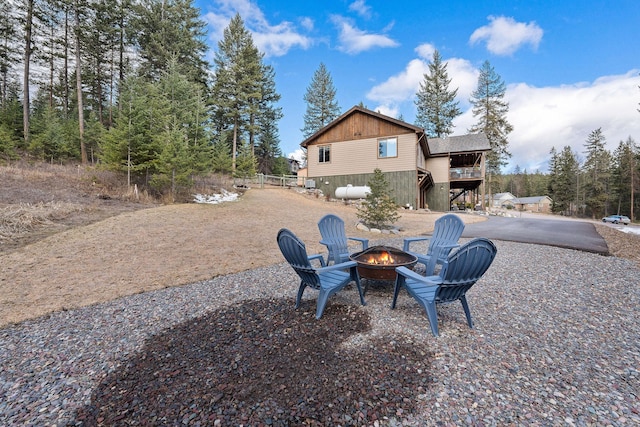 378 Skookum Rd, Lakeside, MT 59922 - view of yard featuring an outdoor fire pit, stairs, a wooden deck, and a patio area