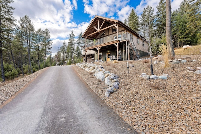 378 Skookum Rd, Lakeside, MT 59922 - view of front facade with a wooden deck, stairway, and driveway