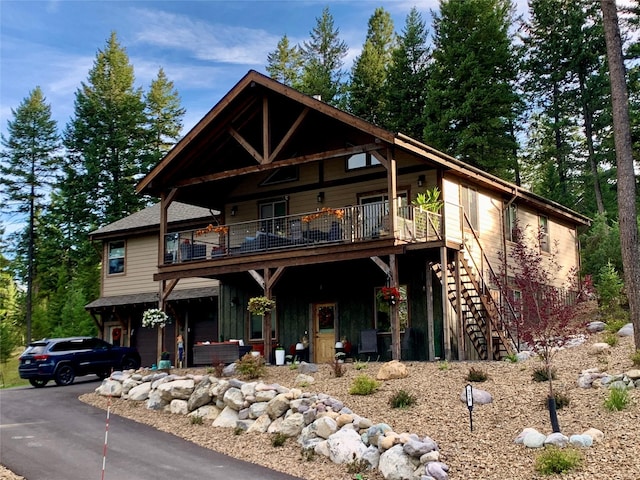 378 Skookum Rd, Lakeside, MT 59922 - view of front facade with an attached garage, driveway, and a balcony