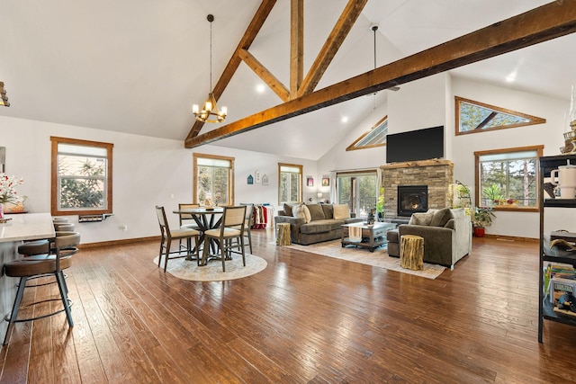 378 Skookum Rd, Lakeside, MT 59922 - living room featuring high vaulted ceiling, a chandelier, beam ceiling, hardwood / wood-style flooring, and a stone fireplace