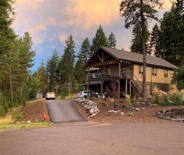 378 Skookum Rd, Lakeside, MT 59922 - view of front of house with asphalt driveway, stairs, and a wooden deck