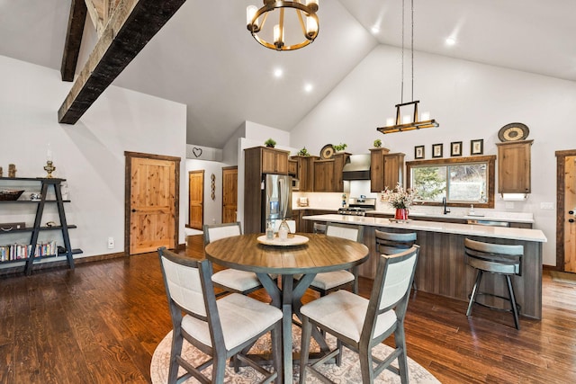 378 Skookum Rd, Lakeside, MT 59922 - kitchen with high vaulted ceiling, a chandelier, light countertops, stainless steel fridge with ice dispenser, and wall chimney range hood