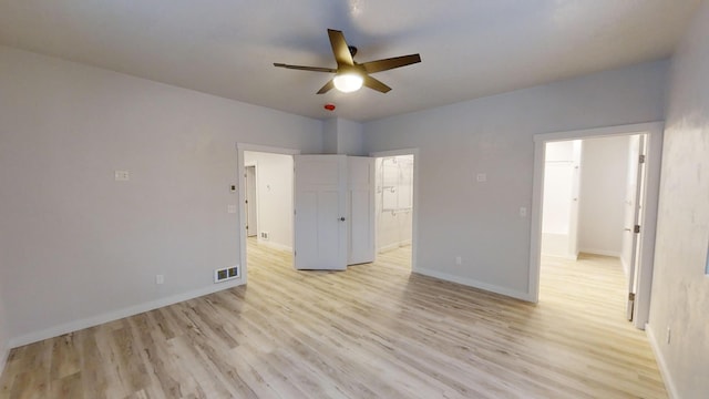 3805 US Highway 93 N, Eureka, MT 59917 - unfurnished bedroom with light wood finished floors, connected bathroom, and ceiling fan