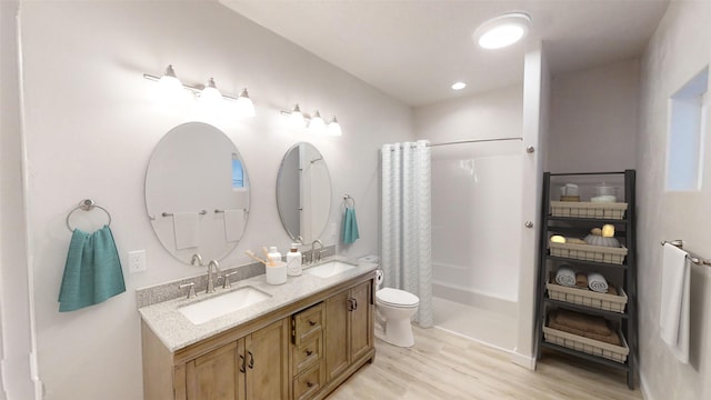 3805 US Highway 93 N, Eureka, MT 59917 - bathroom featuring wood finished floors, double vanity, a shower with shower curtain, and recessed lighting