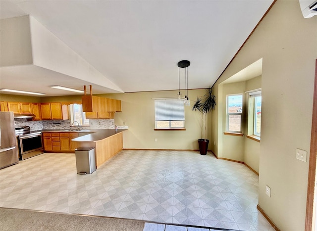 54650 Herak Rd, Charlo, MT 59824 - kitchen with a wealth of natural light, stainless steel appliances, a peninsula, and vaulted ceiling