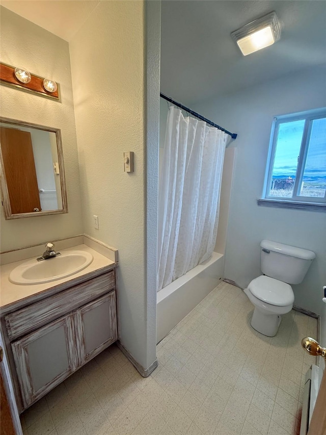 54650 Herak Rd, Charlo, MT 59824 - full bathroom with vanity, toilet, shower / bath combo with shower curtain, and tile patterned floors