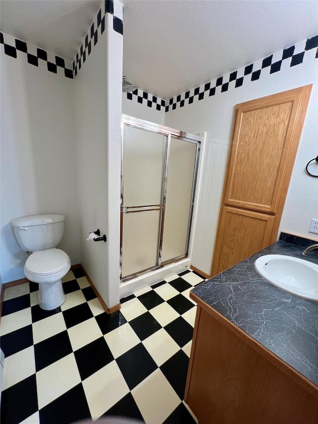 54650 Herak Rd, Charlo, MT 59824 - full bath with a stall shower, vanity, toilet, and tile patterned floors