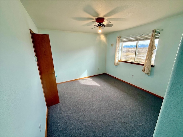 54650 Herak Rd, Charlo, MT 59824 - unfurnished room with baseboards, ceiling fan, and carpet