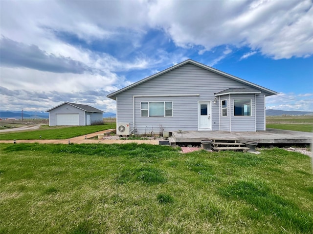 54650 Herak Rd, Charlo, MT 59824 - back of house with a lawn, a detached garage, an outbuilding, and a deck
