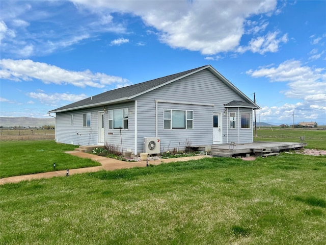 54650 Herak Rd, Charlo, MT 59824 - rear view of property featuring a wooden deck, ac unit, and a lawn