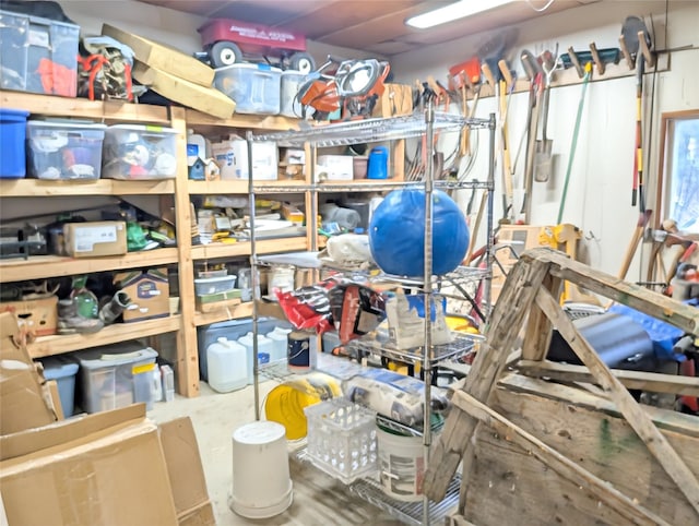 office area with unfinished concrete flooring and a wood stove